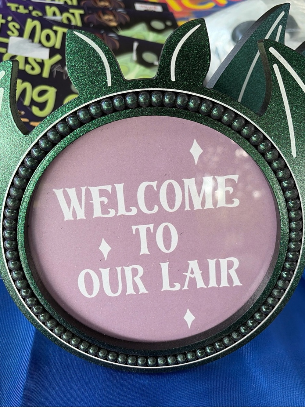 Welcome to Our Lair Decorative Sign - Green Frame, Pink Insert